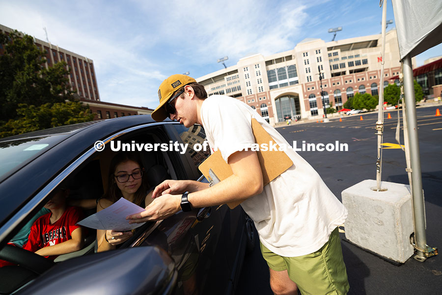 Cody Hora, a senior studying mechanical engineering, helps direct families to residence halls and an