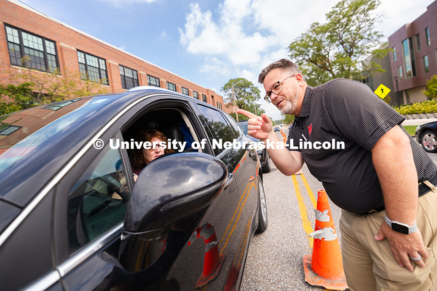 Josh Overocker, Associate Vice Chancellor for Student Life, directs a family toward the Memorial Sta