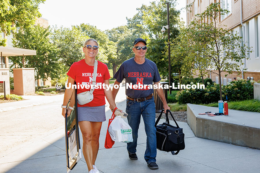 250820_Move_In_323.jpg The Weese family, sporting “Husker Mom and Husker Dad” T-Shirts, carry their son’s items into
