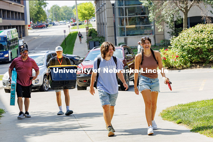 250820_Move_In_534.jpg Meghan Dupre (far right) laughs as she walks into University Suites on move-in day. Residence hall m