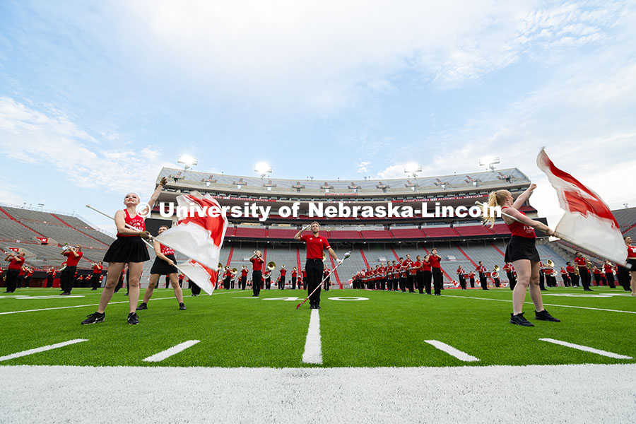 Tanner Maas, one of the 2025 drum majors, holds a salute as the band plays "There is No Place Like N