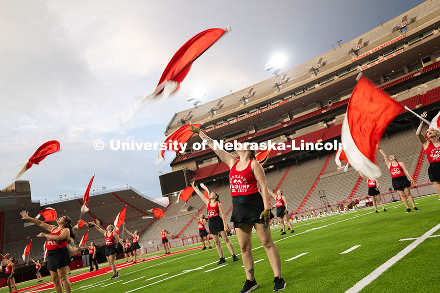 The color guard toss their flags during a performance in Memorial Stadium as part of the band exhibi