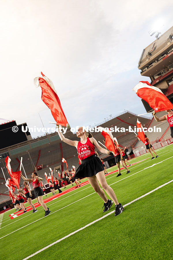 Members of the color guard catch their flags during the band exhibition. Cornhusker Marching Band ex