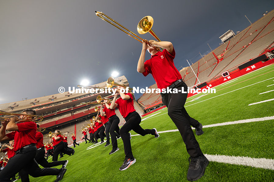 A smattering of raindrops fall on members of the trombone line as they pose during one of several sp