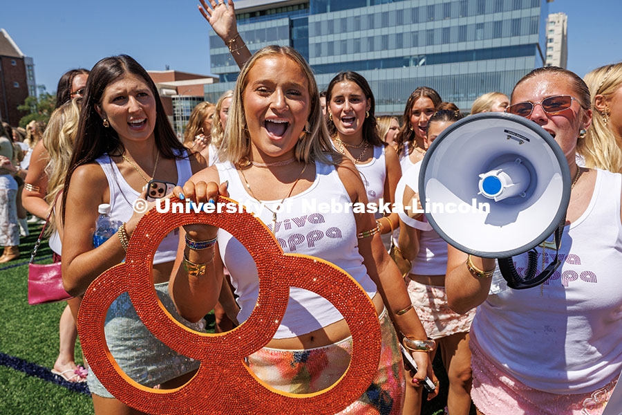 Members of the Kappa Kappa Gamma sorority cheer while waiting for potential new members to open thei
