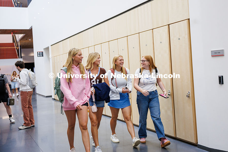 A group of friends walk through the main hallway of the brand-new Fine and Performing Arts Building 