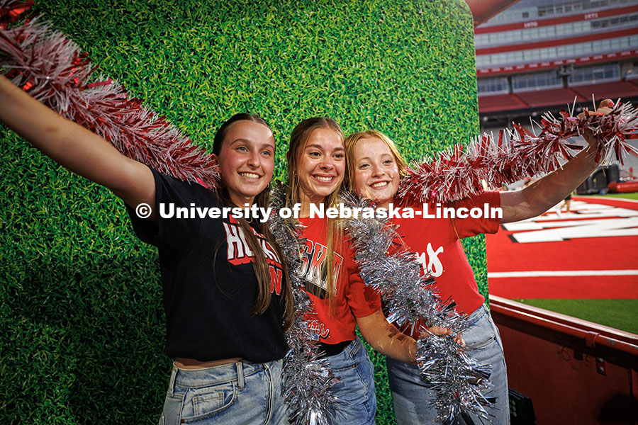 250828_Watch_Party_196.jpg Sierra Rasmussen (left), Hailey Haynes and Claire Lalim pose at the photo booth for the Nebraska vs.
