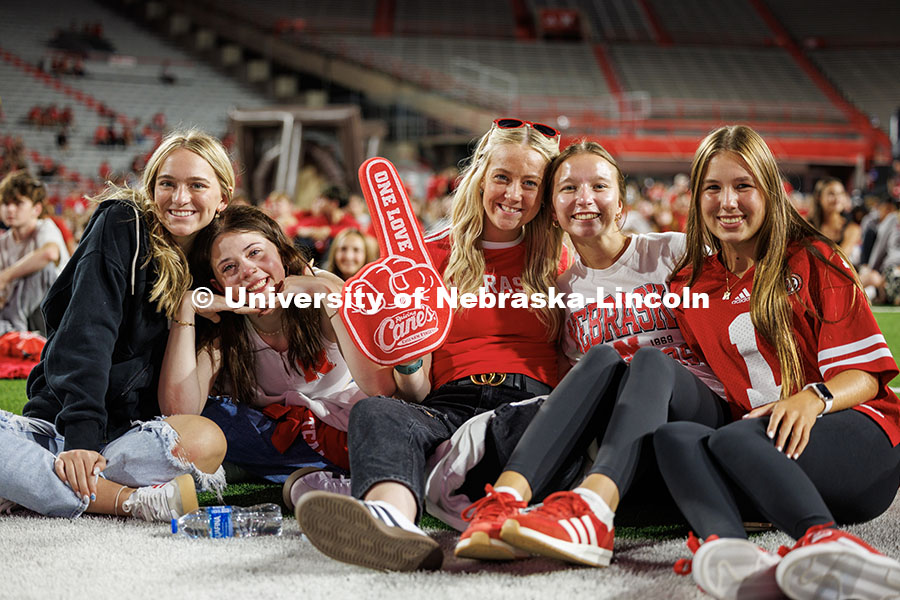 A group of students pose with a foam finger at the Nebraska vs. Cincinnati football game watch party