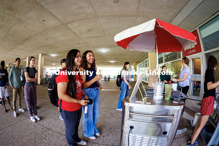 (Left to right) Leonela Perez and Julia Perez get ice cream from library staff in celebration of the