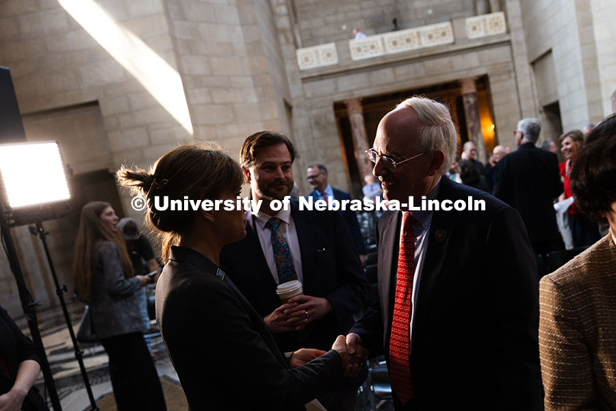 Jeffrey Gold, President of the University of Nebraska System, shakes hands with Leirion Gaylor Baird