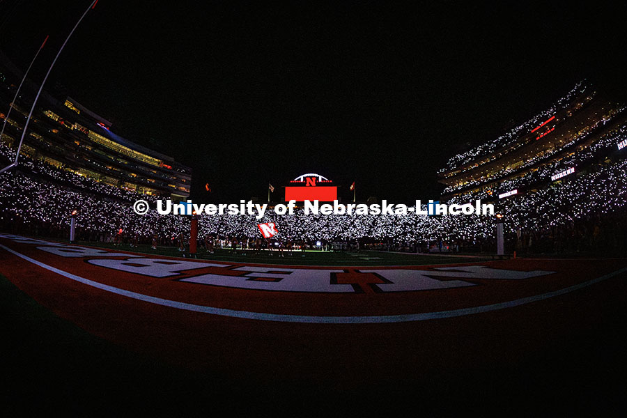 Fans light up the stands with their phones during the 3rd quarter light show at the Nebraska vs Akro