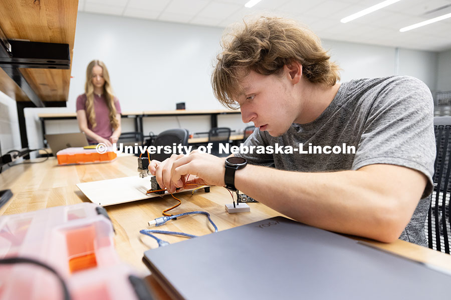 Ian Gouldie, right, and Aleksandra Stansbury, sophomores, robotics engineering majors, connect their