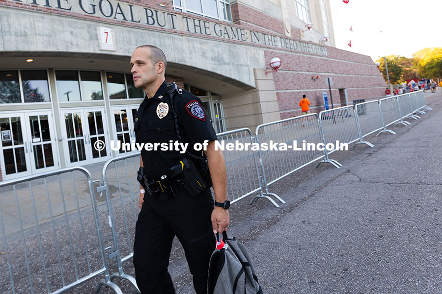 250913_Backer_7276.jpg University Police Captain John Backer walks in front of Gate 7 before the NU vs. Houston Christian U