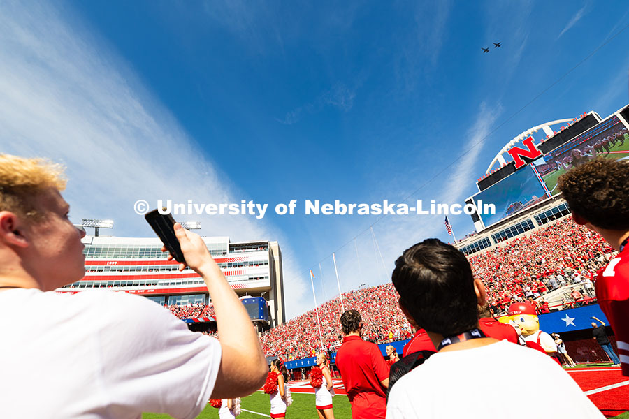 250913_NU_vs_HCU_7317.jpg Two young Husker fans watch the flyover from the northeast sidelines before the game. Nebraska footb