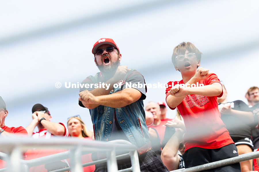 250920_NU_vs_Michigan_8043.jpg Myron Schneider and his son, Paxon, throw the bones from their seats in the east stadium during the