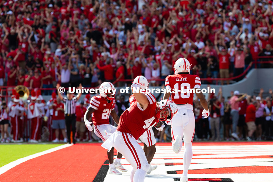 Luke Lindenmeyer dances in the endzone as Husker fans cheer in the background. The team entered half