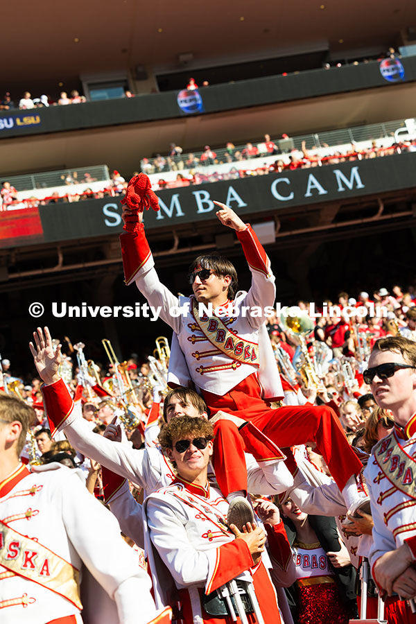 Band members hoist Shane Daughtrey, a senior vocal performance major, for the Simba cam during the g