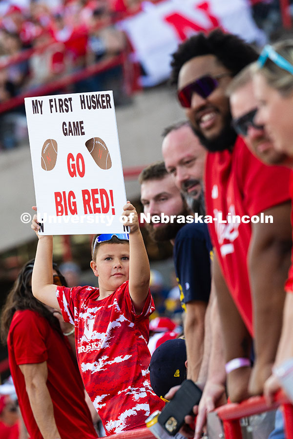 250920_NU_vs_Michigan_8248.jpg Grayden Gadeken holds up a sign that reads "My first Husker game, Go Big Red!" He and his parents ca