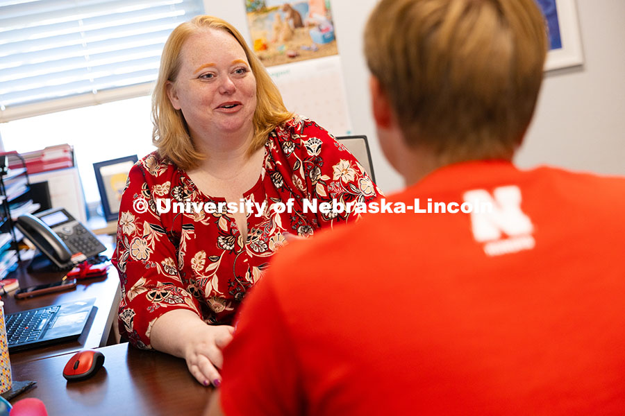 Tamy Burnett, Honors Program Director of Operations, speaks with Troy Kallhoff, a sophomore in the p