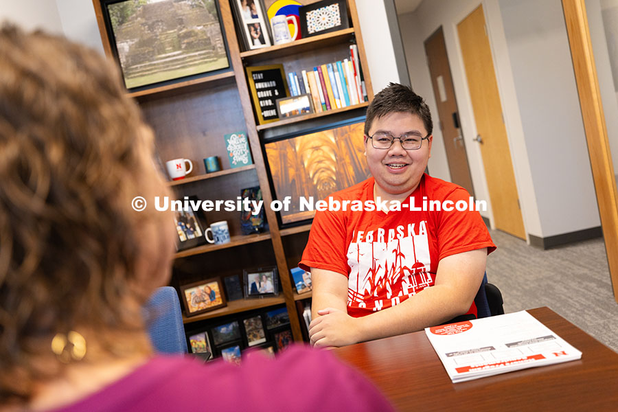 Huy Le, a senior in the Honors Program studying agricultural economics, speaks with Rebecca Baskervi