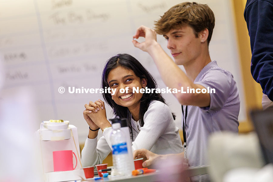 Riya Pawar, left, sophomore computer science and data science double major, listens as her group pra