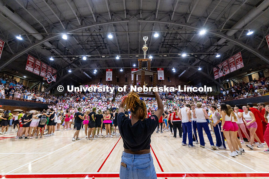 250929_Showtime 2025_2770.jpg A member Campus Nightlife holds up a trophy in front of the crowd as they prepare to award the winne