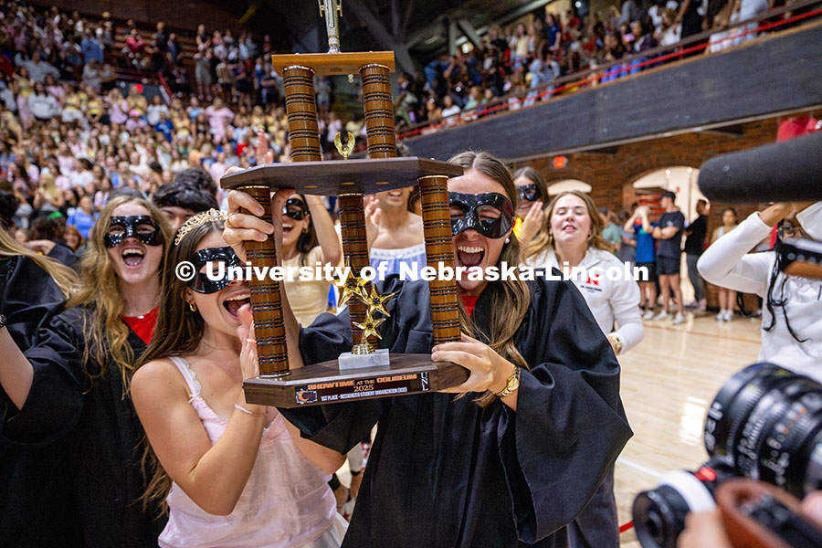 Mortarboard holds up the first-place trophy after winning showtime for their category. Recognized St