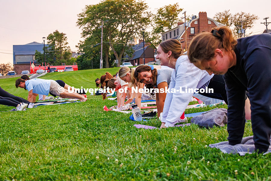 Students laugh as they hold a plank during the Pilates Pop-Up event held by Campus Rec at the 17th S