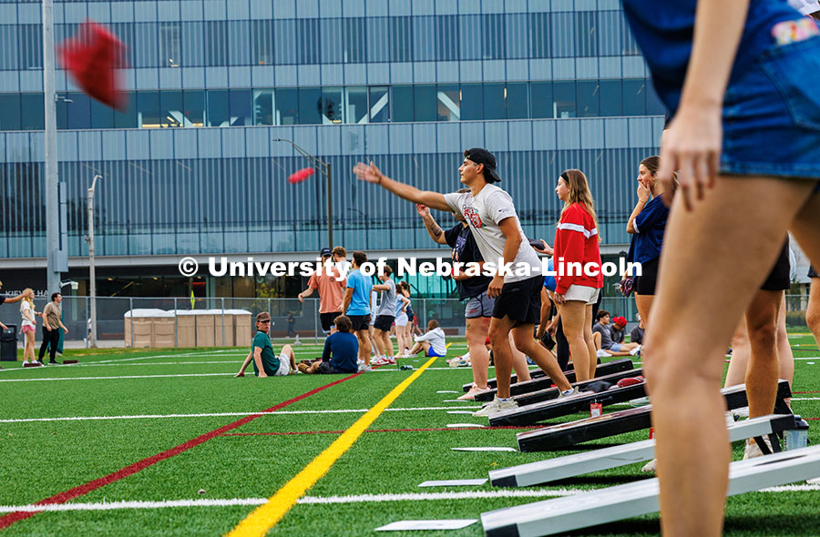 TJ Leiferman (tan shirt), a sophomore Mechanical Engineering major, throws the bean bag in a game of