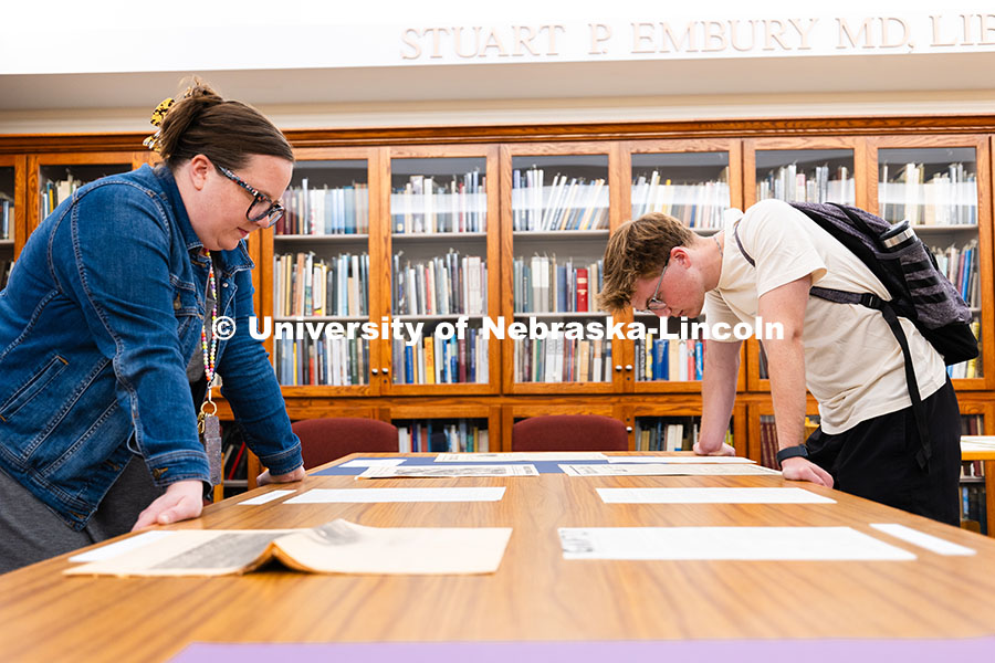 Nicklas Stefanik (right), a sophomore majoring in political science, reviews documents pulled from t