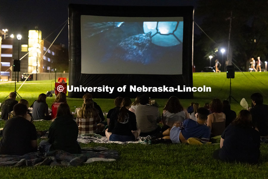 Students gather on blankets and folding chairs on the lawn outside of Willa Cather Dining Complex to