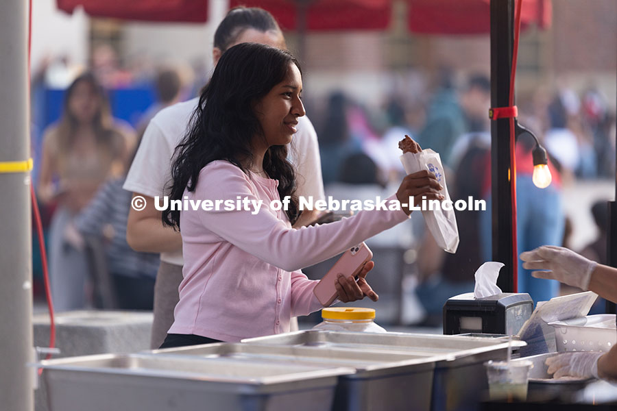 First-year student Sandarika Warjri picks up a churro from Papi Churros with a friend during the fir