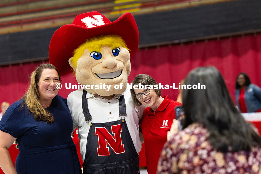251003 Service Awards 8827.jpg Angela Rushing (left) and Karen Bentz (right) pose for a photo at the photo booth with Herbie Husker
