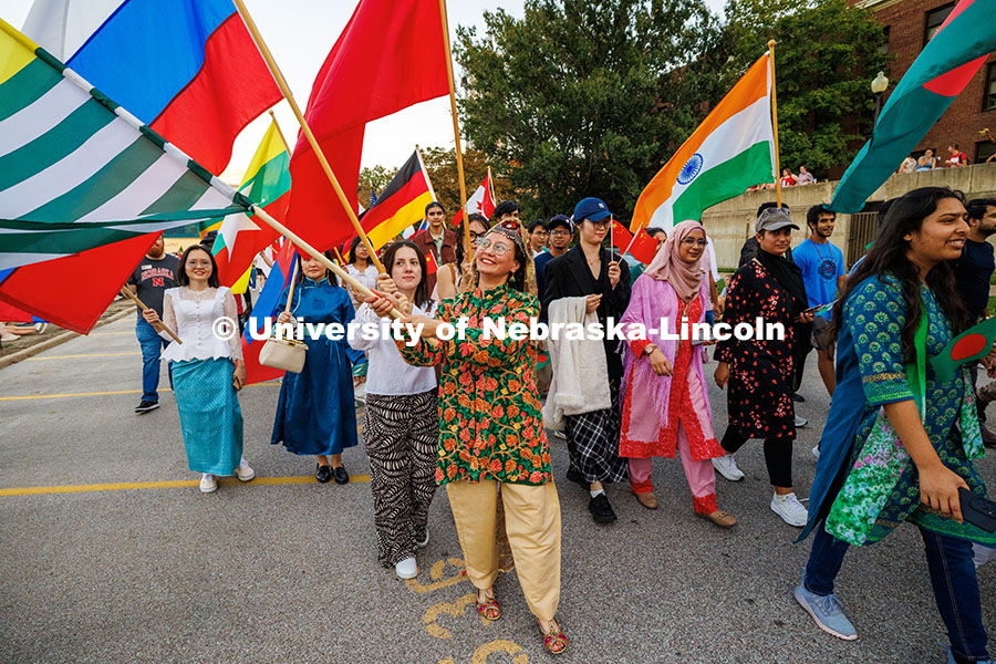 251003_Homecoming_Parade_390.jpg International students wave their flags as they walk in the 2025 Homecoming parade. Homecoming parad