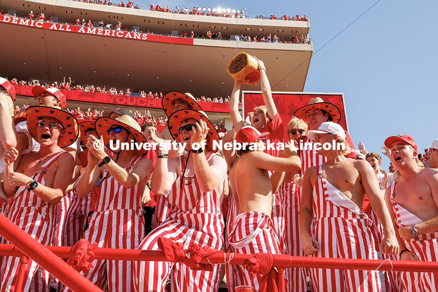 251004_NU_vs_MSU_318.jpg Fans dressed in striped overalls cheer after the Huskers scored a touchdown. Nebraska vs Michigan St