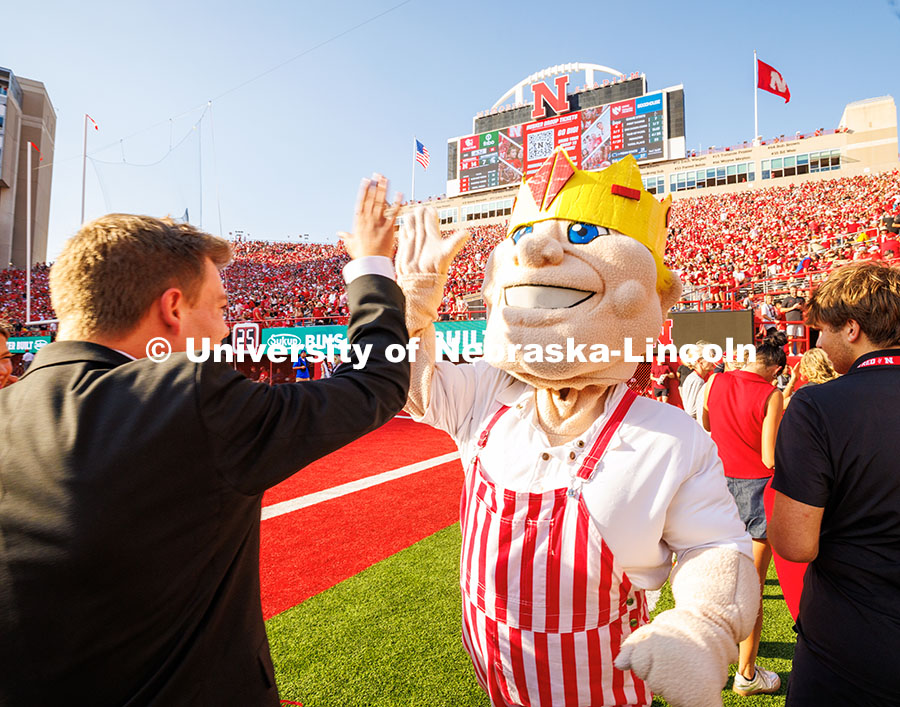 Herbie Husker high-fives Caden Connelly newly crowned Homecoming King. This was the first year ever 