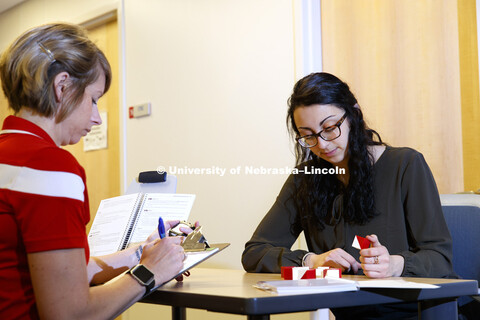 Jennie Laeng takes a concussion test using block patterns under the supervision of Kate Higgins, Pos