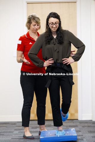 Jennie Laeng performs a balance test as part of a concussion screening under the supervision of Kate