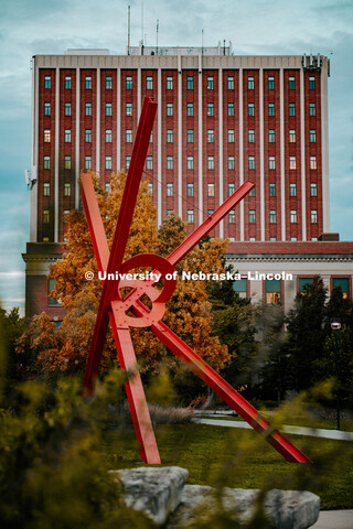 Old Glory Statute in front of fall trees framed by Old-father Hall, Fall on City Campus. October 18,