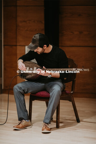 Our Nebraska: Express Yourself Expo in the Oasis Center. A Turkish student plays a sting instrument 