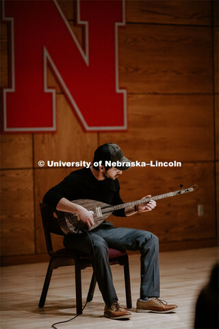 Our Nebraska: Express Yourself Expo in the Oasis Center. A Turkish student plays a sting instrument 