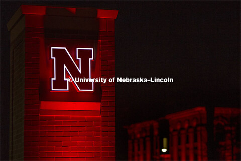 The East Campus gateway / entrance columns are lit up for Glow Big Red. Glow Big Red bathes the camp