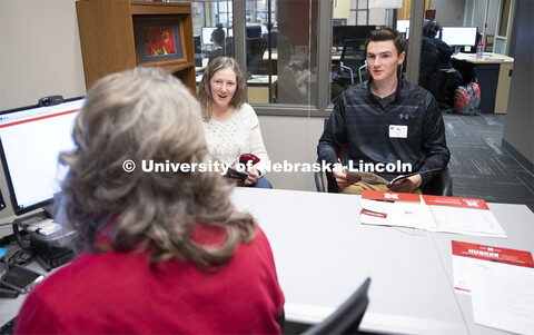 Anna Plank, assistant director of Husker Hub, talks with student Ben Houck and his mother, Cheryl, i