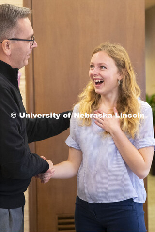 Emily Johnson, a junior at the University of Nebraska, reacts with surprise as Chancellor Ronnie Gre