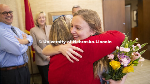 Emily Johnson, a junior at the University of Nebraska, gets a congratulatory hug from Laura Damuth, 