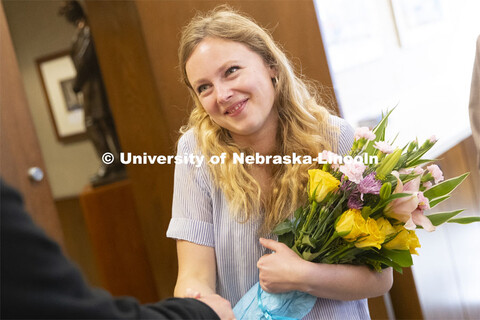 Emily Johnson, a junior at the University of Nebraska, reacts as Chancellor Ronnie Green tells her s