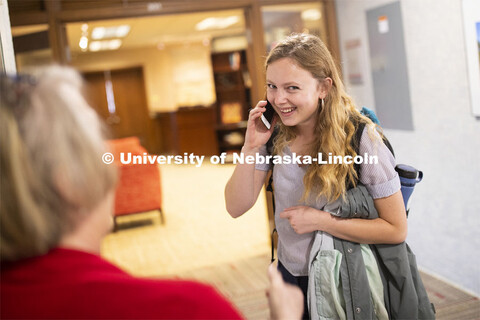 Emily Johnson, a junior at the University of Nebraska, talks with her mom over the phone following t