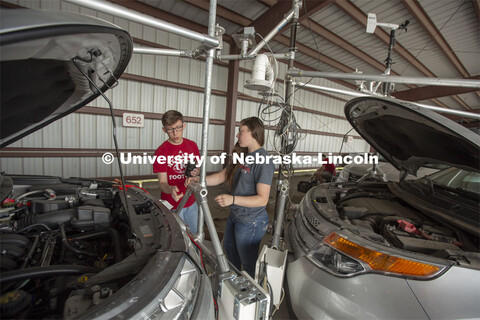 Nebraska students (from left) Brennan Darrah and Maddy Diedrichsen discuss how to attach instrumenta