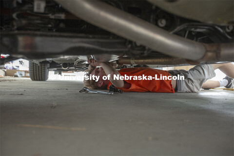 Ben Schweigert, a freshman meteorology major from Omaha, tightens a bolt that holds a tower for a co