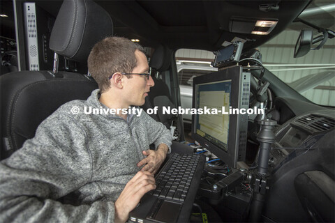 Graduate student Matt Wilson reviews code in programs that are used to collect real-time storm data.